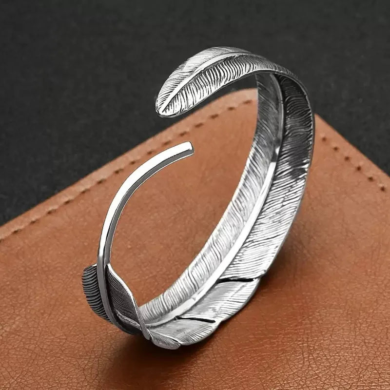 Antiqued silver feather cuff, side view showing the open feather band