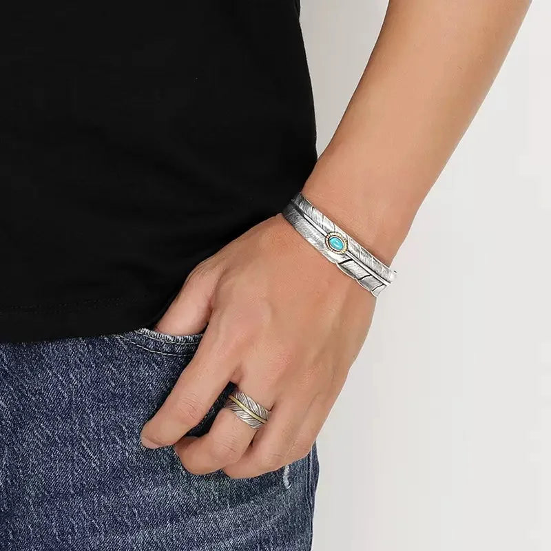 Antiqued silver feather turquoise cuff worn on the wrist