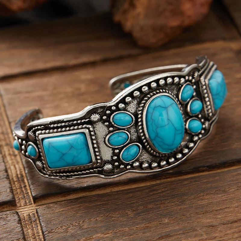 Side angle of the Wide Southwestern Turquoise Statement Cuff on rustic wood