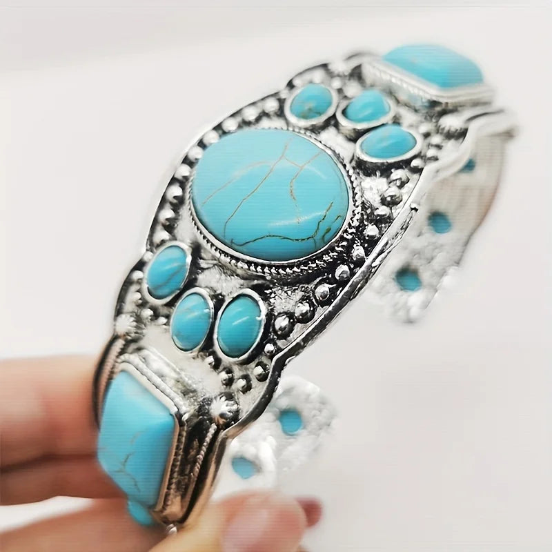 Wide Southwestern Turquoise Statement Cuff held in hand to show its size and turquoise oval
