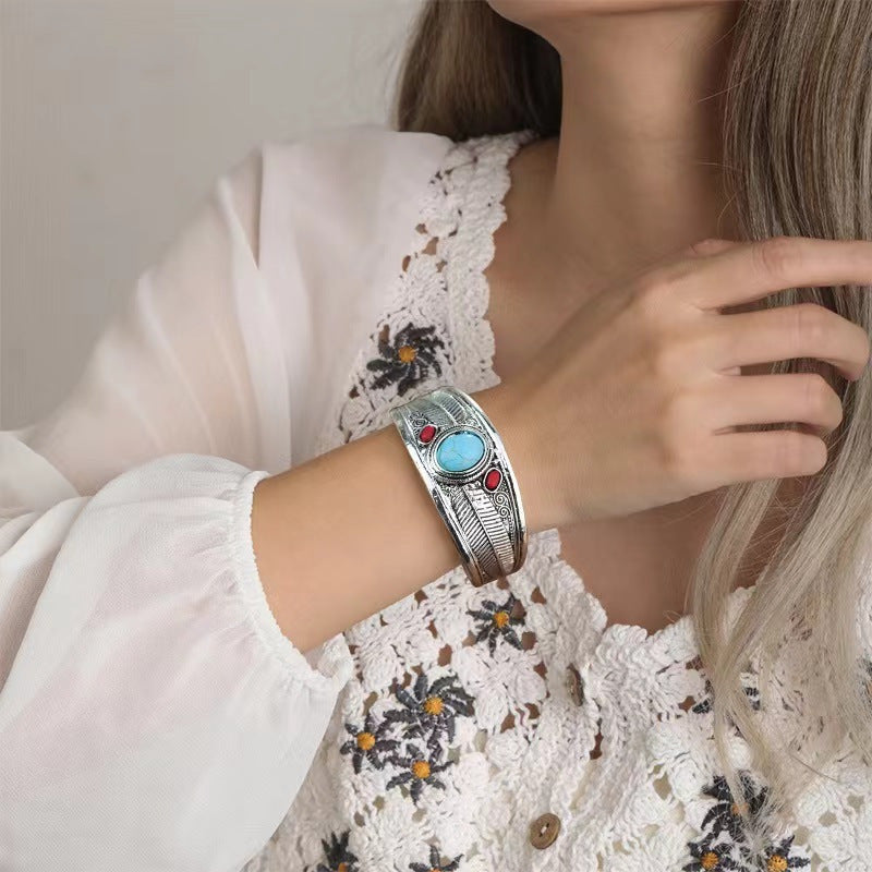 Silver feather turquoise coral cuff worn on the wrist